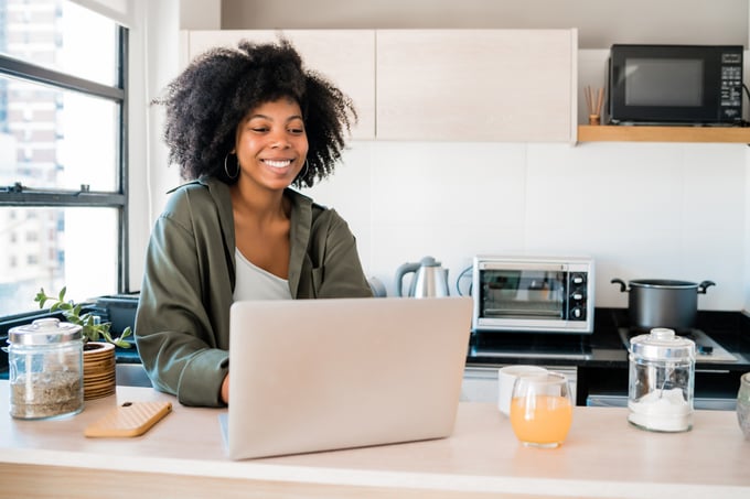 Woman at a laptop in her kitchen