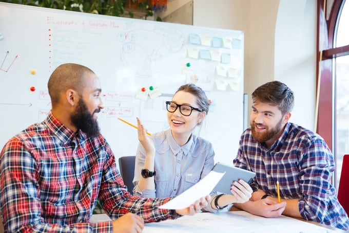 Group of happy business people discussing together in office